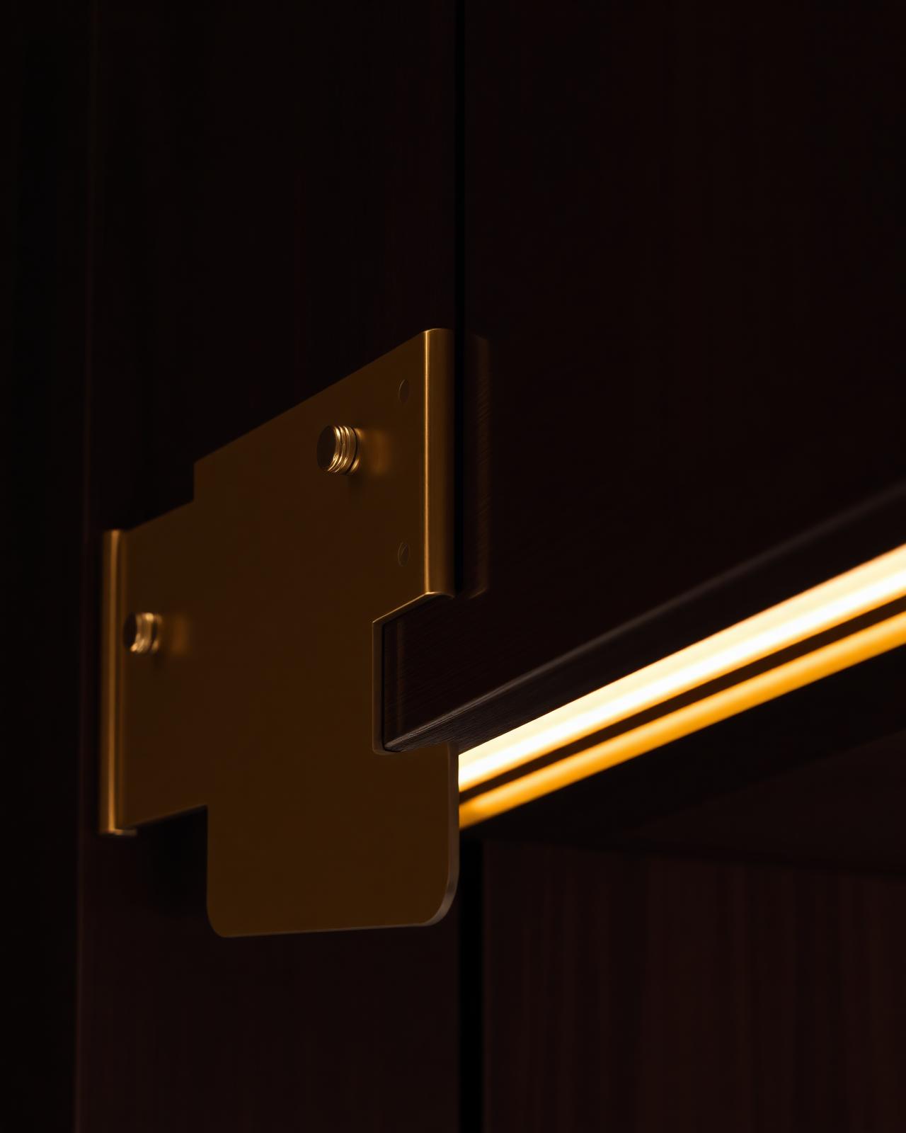 Detail of bespoke joinery and brass craftsmanship